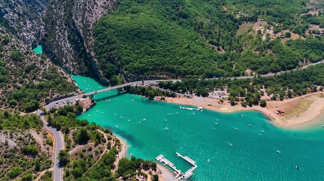 Aerial drone view of the turquoise Verdon River flowing through the Verdon Gorge river canyon in the Provence-Alpes-Cote d'Azur region of southeastern France. High quality 4k footage