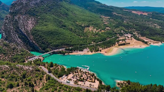 Aerial drone view of the turquoise Verdon River flowing through the Verdon Gorge river canyon in the Provence-Alpes-Cote d'Azur region of southeastern France. High quality 4k footage