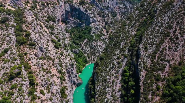 Aerial drone view of the turquoise Verdon River flowing through the Verdon Gorge river canyon in the Provence-Alpes-Cote d'Azur region of southeastern France. High quality 4k footage