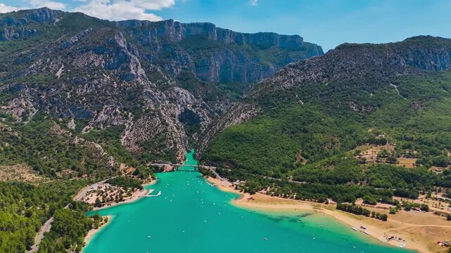 Aerial drone view of the turquoise Verdon River flowing through the Verdon Gorge river canyon in the Provence-Alpes-Cote d'Azur region of southeastern France. High quality 4k footage