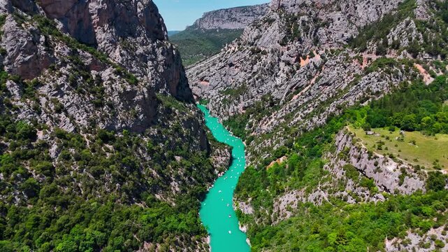 Aerial drone view of the turquoise Verdon River flowing through the Verdon Gorge river canyon in the Provence-Alpes-Cote d'Azur region of southeastern France. High quality 4k footage