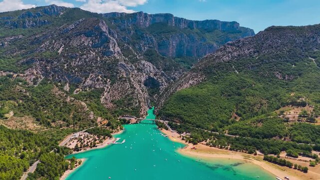 Aerial drone view of the turquoise Verdon River flowing through the Verdon Gorge river canyon in the Provence-Alpes-Cote d'Azur region of southeastern France. High quality 4k footage
