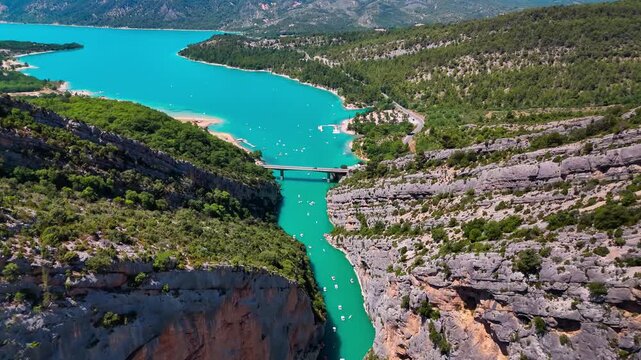Aerial drone view of the turquoise Verdon River flowing through the Verdon Gorge river canyon in the Provence-Alpes-Cote d'Azur region of southeastern France. High quality 4k footage