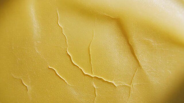Close-up slow motion of golden cheese slice melting beautifully