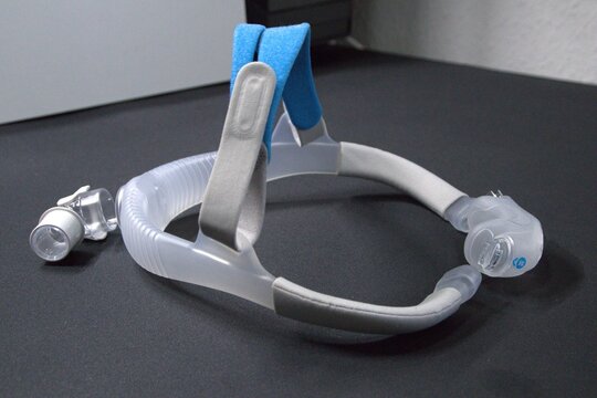 Disassembled CPAP nose mask or nasal CPAP cradle mask shows replaceable parts of CPAP headgear clip. Sleep apnea and sleep disorder with snoring stopped by respirator mask and CPAP machine treatment.