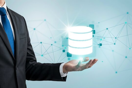 Professional businessman holding a glowing database server icon for cloud computing data