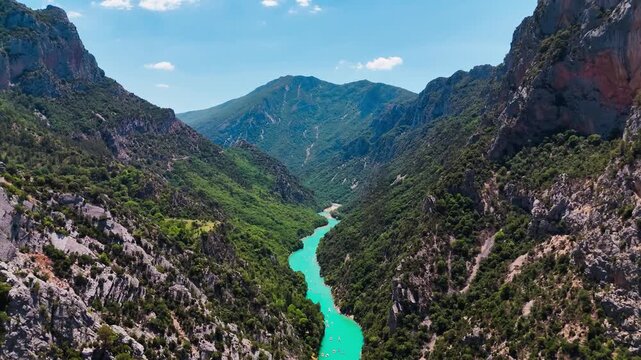 Aerial drone view of the turquoise Verdon River flowing through the Verdon Gorge river canyon in the Provence-Alpes-Cote d'Azur region of southeastern France. High quality 4k footage