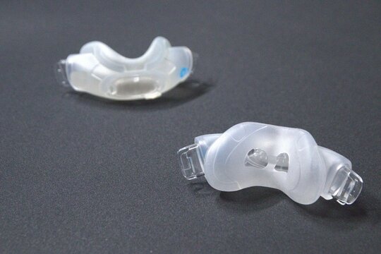 Old nasal CPAP mask or old nasal CPAP cradle cushion needs replacement for hygienic sleep apnea disorder therapy. Sleep apnea and sleep disorder with snoring stopped by respirator mask CPAP machine.