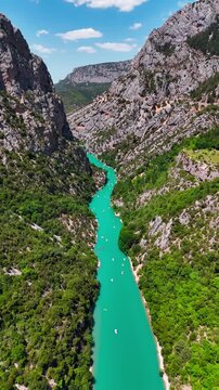 Aerial drone view of the turquoise Verdon River flowing through the Verdon Gorge river canyon in the Provence-Alpes-Cote d'Azur region of southeastern France. High quality 4k footage