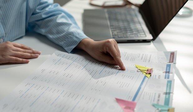 Human resources professional reviewing resume and job application documents for candidate selection. Recruitment process, hiring, talent acquisition, employee evaluation, interview, and workforce mana
