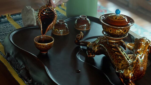 The hands making a tea ceremoy on the wooden table before start of the sound healing