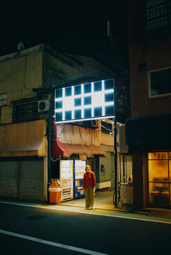 Woman standing in the alley n Tokyo, Japan at night 