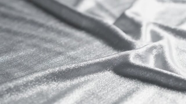 Fabric Texture with Shimmering Silver Material Gently Rippling and Creating Elegant Abstract Patterns Ideal for Luxurious Backgrounds