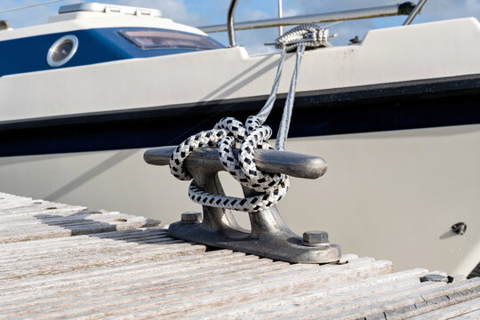 cleat hitch securing a boat line to a metal deck cleat
