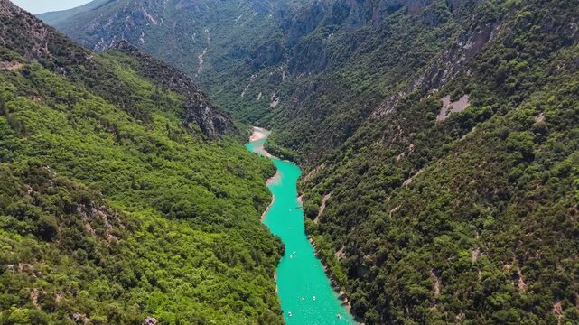 Aerial drone view of the turquoise Verdon River flowing through the Verdon Gorge river canyon in the Provence-Alpes-Cote d'Azur region of southeastern France. High quality 4k footage