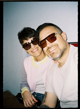 Happy couple smiling wearing sunglasses taking selfie