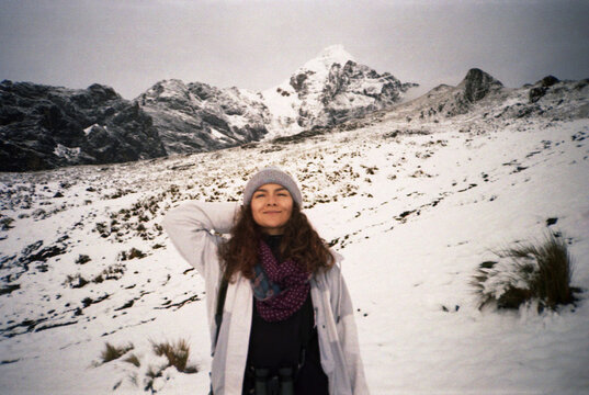 Film Portrait of Happy Woman Standing in Snowy Mountain 