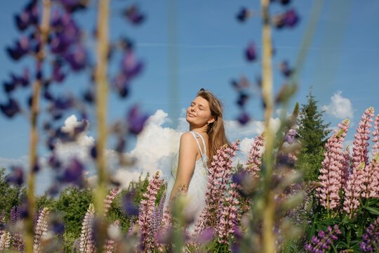 Summer portrait of woman at flower lawn