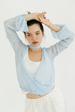 Woman posing in stylish light blue wrap top