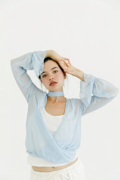 Woman posing with blue wrap blouse