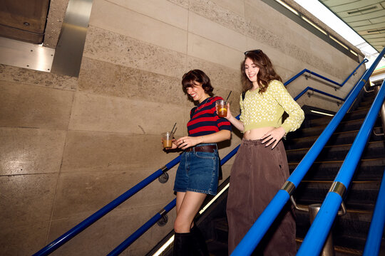 Two attractive women made their way to the subway station.