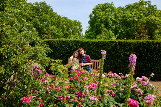 Mother and daughter relish a sunny day in a city park 