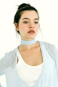 Woman wearing light blue choker and cardigan
