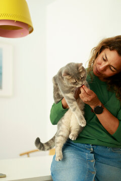 Woman Interacts With Cat at Home