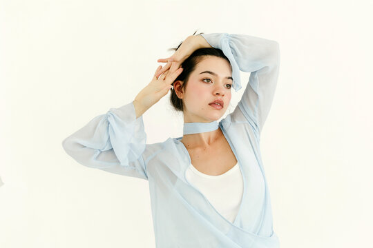 Woman posing in blue sheer fashion garment