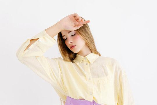 Woman covering eyes with hand 