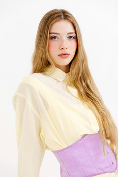 Woman wearing purple corset and yellow shirt