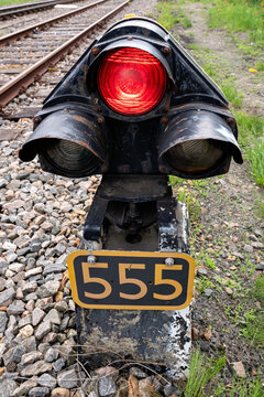 red railway ground signal at rail track