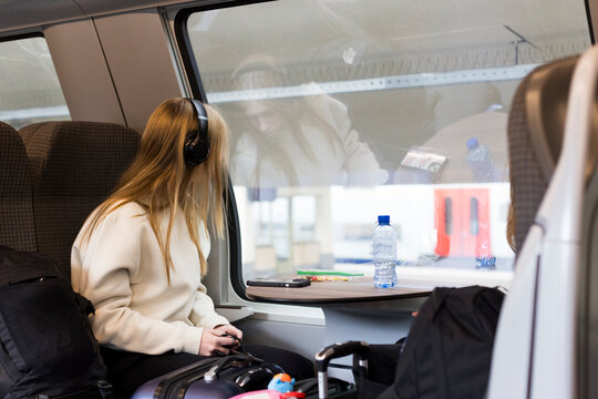 Girl traveling by train in Europe