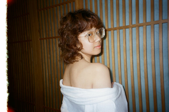 Candid Portrait of Woman in Bathrobe With Glasses