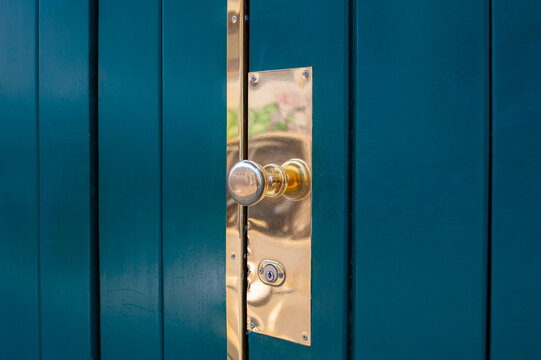Close Up of Blue Front Door with Brass Golden Doorknob