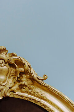 Decorative Gold Frame With Floral Design on Blue Wall