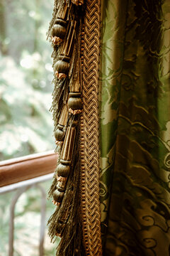 Curtain With Tassels Near a Window in a Room