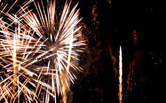 Colourful fireworks are glowing in the night sky. Happy new year concept.