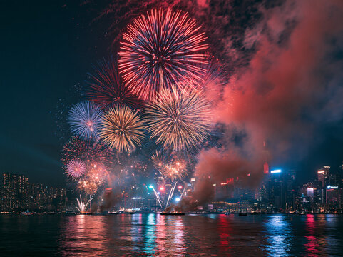 Colorful Fireworks Display Over City Skyline Reflecting on River at Night, Festive Celebration, New Year Festival, Waterfront Panorama