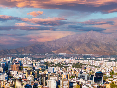 Panoramic view of Santiago city skyline with Andes mountains in the background at sunset
