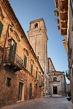 Vasto, Abruzzo, Italy. Narrow ancient street in the old town with the historic church of Santa Maria Maggiore and its bell tower.