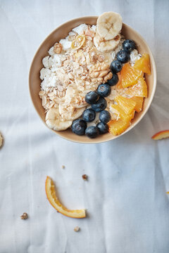 Healthy breakfast with oatmeal cereal, banana, blueberry, orange