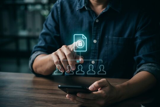 Businessman using smartphone to manage digital data security and team access permissions online