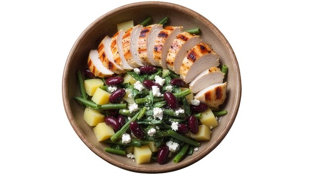 Top-down view of a healthy salad with sliced grilled chicken, green beans, diced potatoes, kidney beans, and feta cheese in a brown bowl, isolated on a white background.