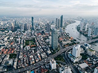 Fototapeta premium Aerial view of the modern bangkok city skyline at sunset
