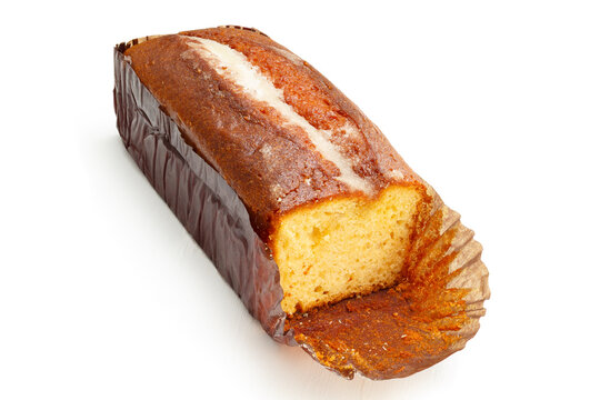 Freshly sliced lemon loaf cake on white background with a moist golden crumb and bakery paper wrapper.