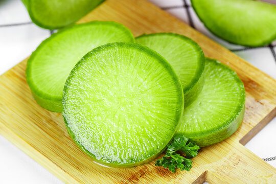 Fresh Green Radish Slices on Wooden Cutting Board - Crisp Asian Vegetable Preparation