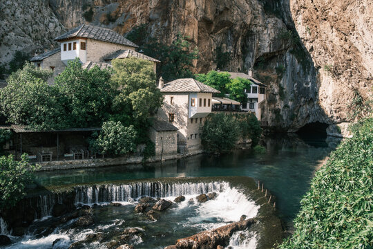 Ottoman-style Blagaj Tekija Sufi lodge reflecting in the tranquil turquoise waters of the karst spring in Bosnia.