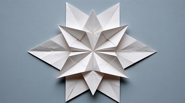 Minimalist white origami star paper craft isolated on a soft blue background for design ideas