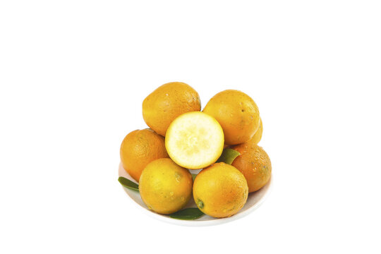 Fresh Kumquat and Longan Fruits on White Plate with Cut Open Citrus Showing Interior